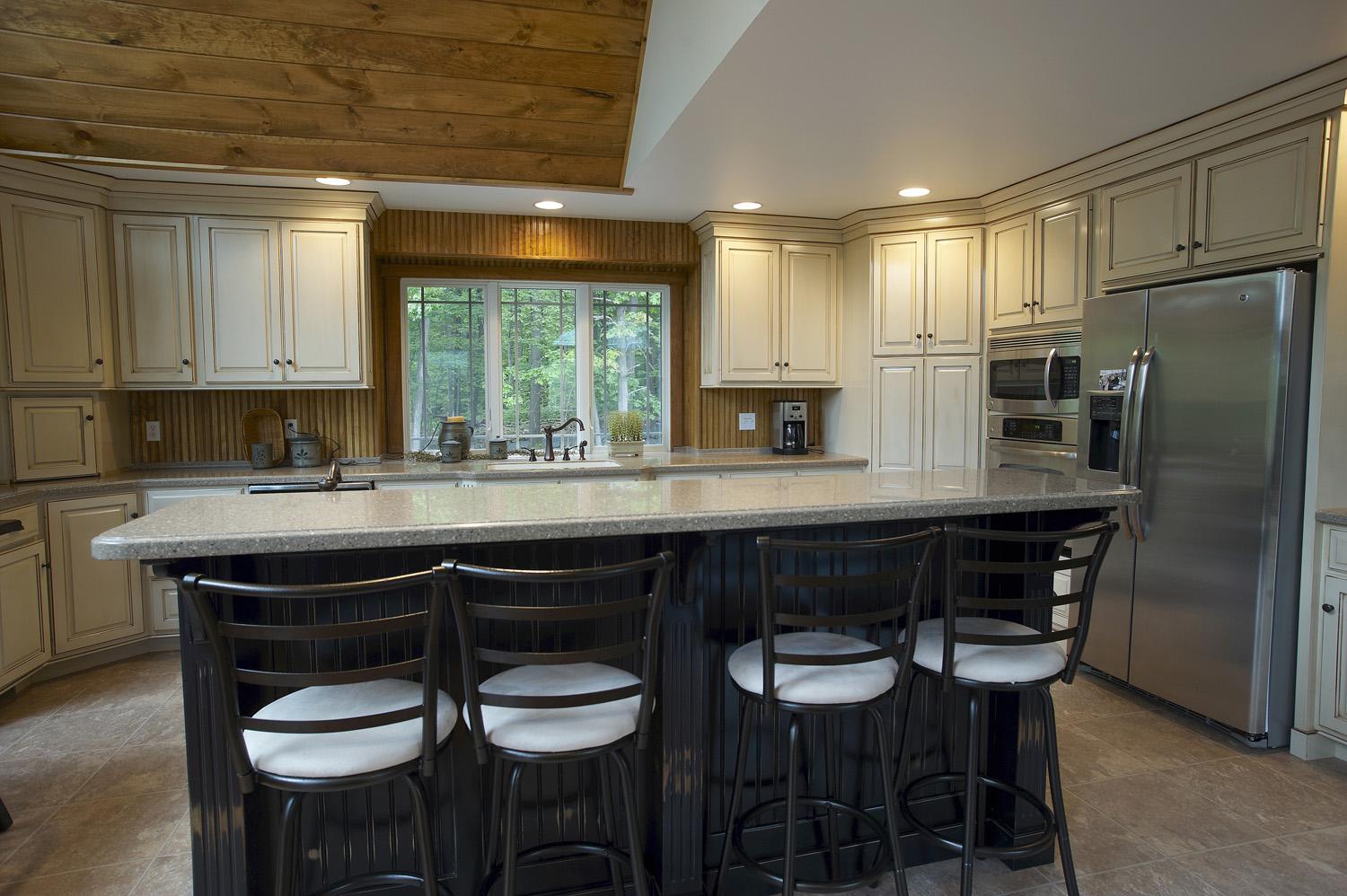Custom made kitchen island with cabinets in the background